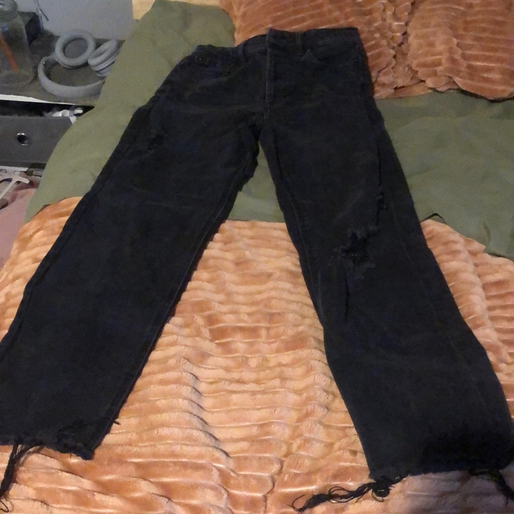 Frayed black ripped jeans